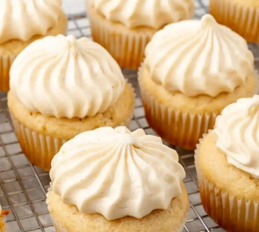 Delicious autumn apple butter cupcakes topped with creamy frosting and spices.