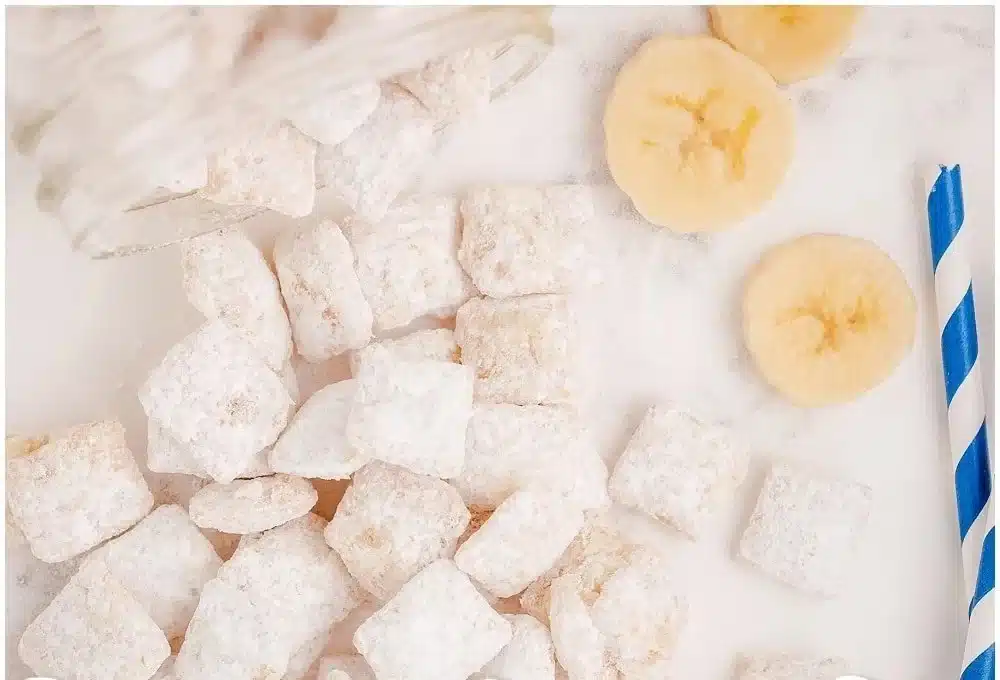 Delicious Banana Cream Pie Muddy Buddies featuring Chex cereal and powdered sugar