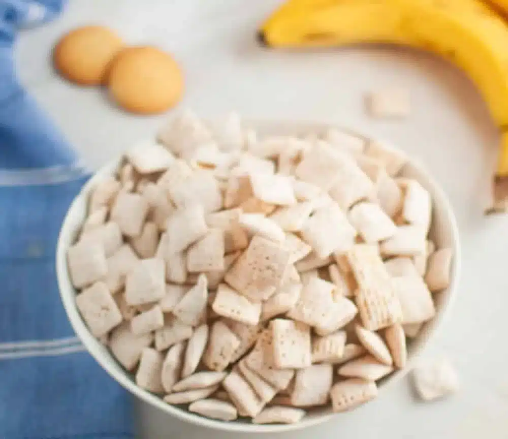 Bowl of Banana Pudding Muddy Buddies snack, resembling puppy chow dessert