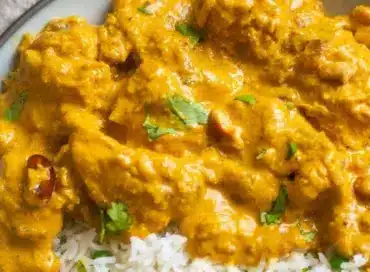 Delicious Chicken Korma served in a bowl with fragrant spices and herbs.