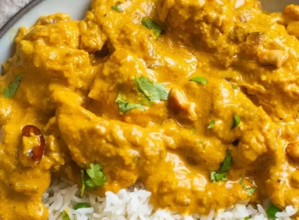 Delicious Chicken Korma served in a bowl with fragrant spices and herbs.
