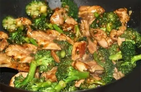 Plate of Chinese Chicken and Broccoli with vibrant vegetables