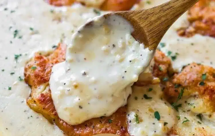 Creamy garlic chicken breast served with herbs and vegetables