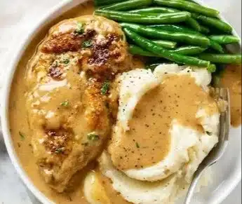 Creamy garlic chicken served with gravy and mashed potatoes.