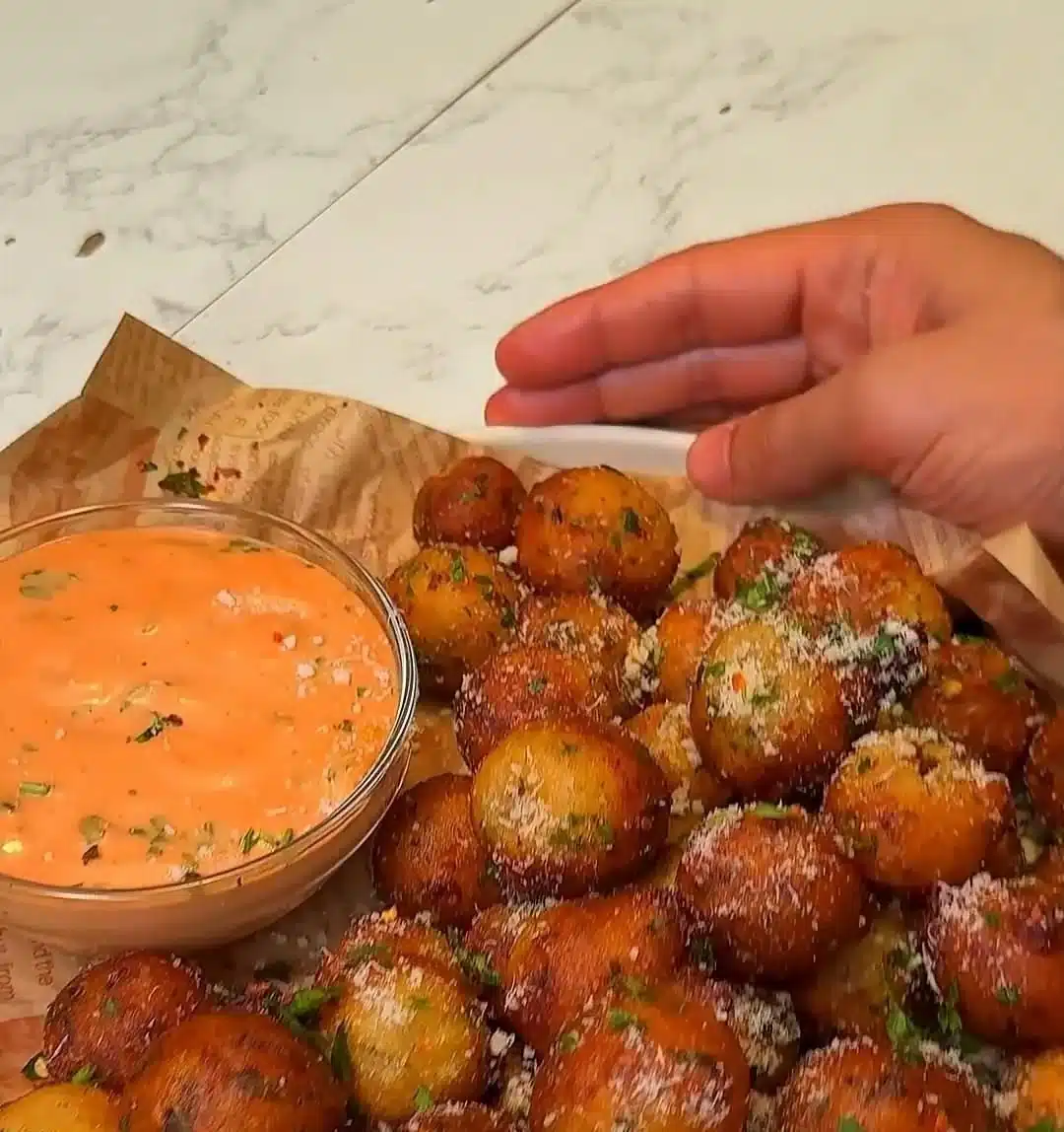 Crispy potato balls served as a tasty snack on a plate.