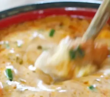Bowl of easy taco soup topped with avocado and cilantro