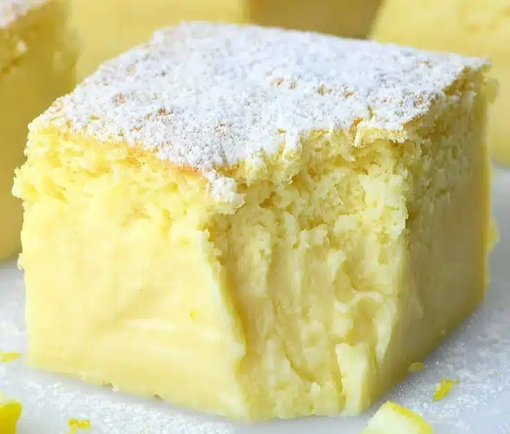Slice of delicious Lemon Custard Cake on a decorative plate
