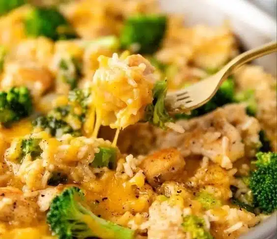 One Pan Cheesy Chicken Broccoli and Rice dish served in a skillet.