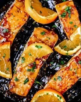 Delicious orange glazed salmon with citrus and garlic served on a plate
