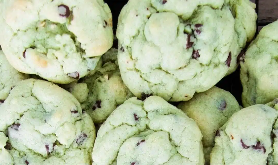 Delicious pistachio pudding cookies with chocolate chips on a baking sheet