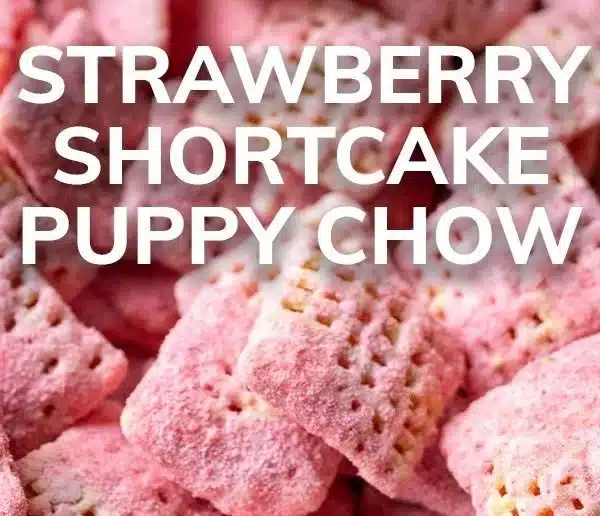 Bowl of Strawberry Shortcake Puppy Chow with colorful sprinkles and strawberries