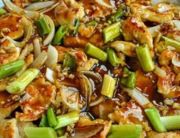 Plate of Sweet and Spicy Mongolian Chicken garnished with green onions.