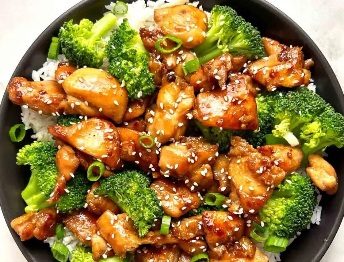 Teriyaki Chicken Rice Bowl garnished with vegetables on a white plate