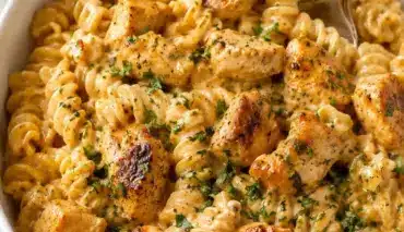 Plate of Cowboy Butter Chicken Pasta garnished with fresh herbs